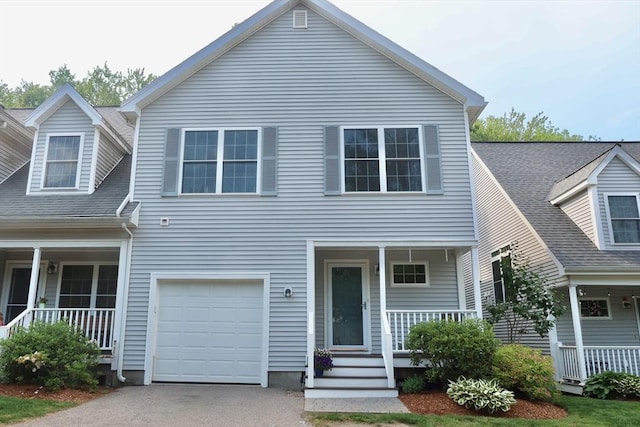 12 Sterling Ln Unit 12, Walpole, MA 02081 - view of front facade featuring covered porch, asphalt driveway, and an attached garage