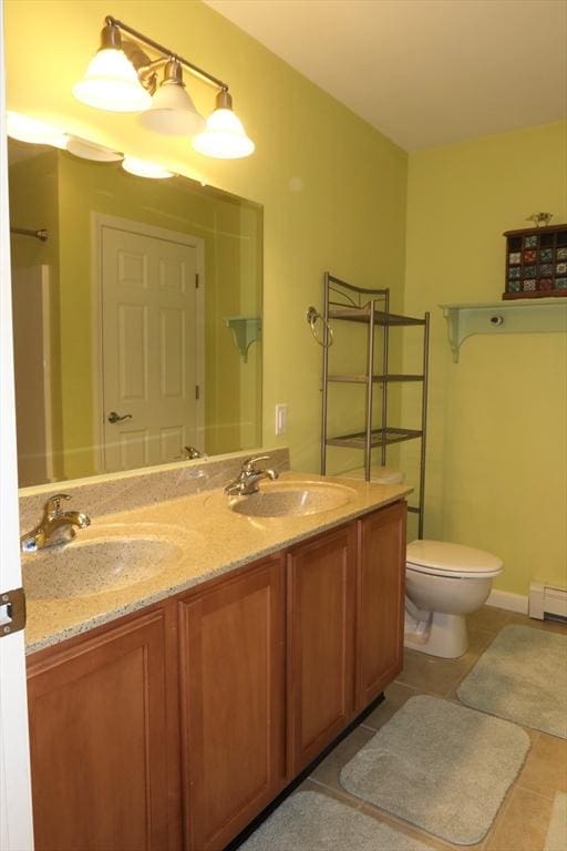 12 Sterling Ln Unit 12, Walpole, MA 02081 - full bath featuring tile patterned flooring, double vanity, toilet, and a baseboard radiator