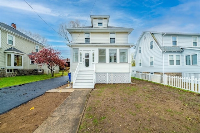 american foursquare style home with fence
