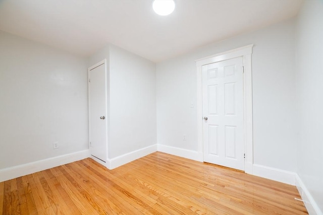 unfurnished room featuring light wood-style flooring and baseboards