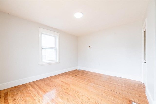 unfurnished room featuring wood finished floors and baseboards