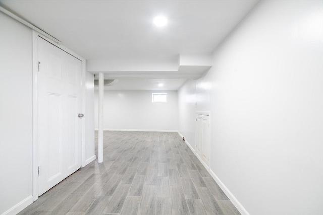 below grade area with light wood-type flooring and baseboards