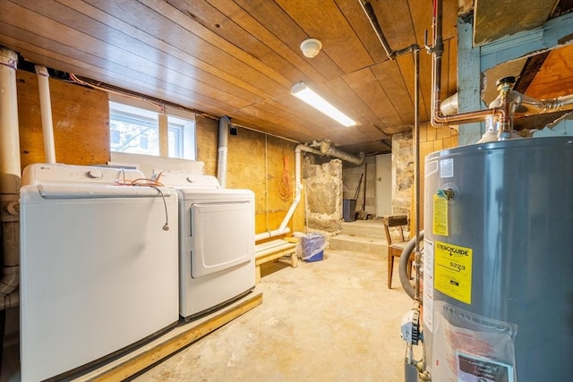 below grade area featuring wood ceiling, water heater, and separate washer and dryer