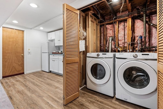 clothes washing area with recessed lighting, light wood-type flooring, baseboards, and separate washer and dryer