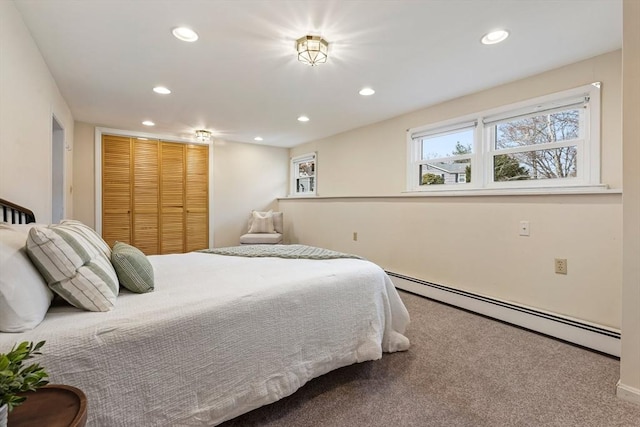 bedroom with a baseboard heating unit, carpet flooring, recessed lighting, and a closet