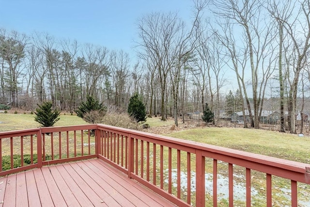 wooden deck featuring a yard