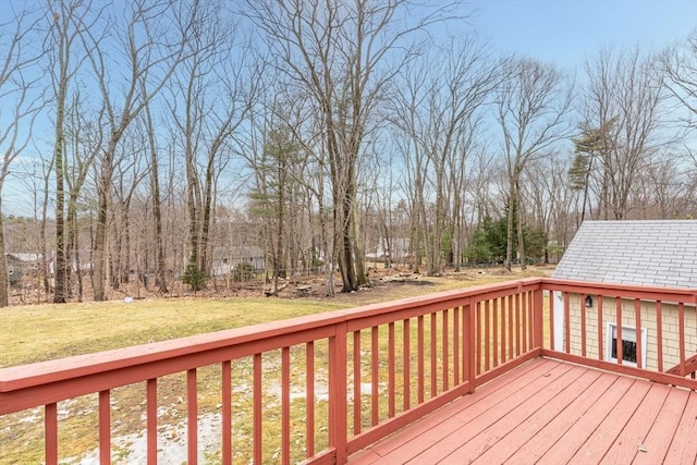 wooden deck featuring a lawn