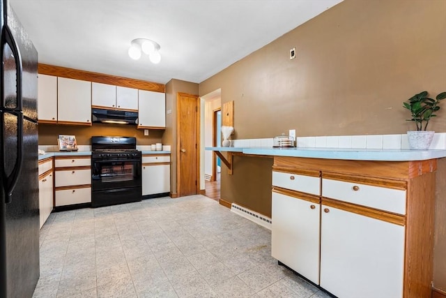 kitchen featuring visible vents, black appliances, under cabinet range hood, light floors, and white cabinetry