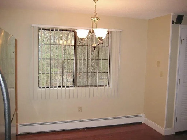 1610 Skyline Dr Unit 11, Lowell, MA 01854 - unfurnished dining area with a chandelier, a baseboard heating unit, wood finished floors, and baseboards