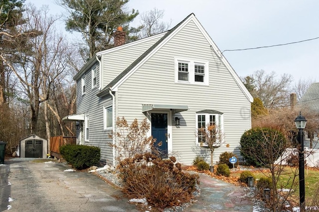 view of front of house featuring a storage shed