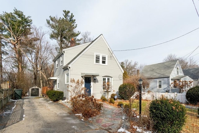 view of front of home with a storage shed