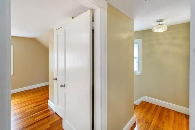 hall with hardwood / wood-style flooring and lofted ceiling