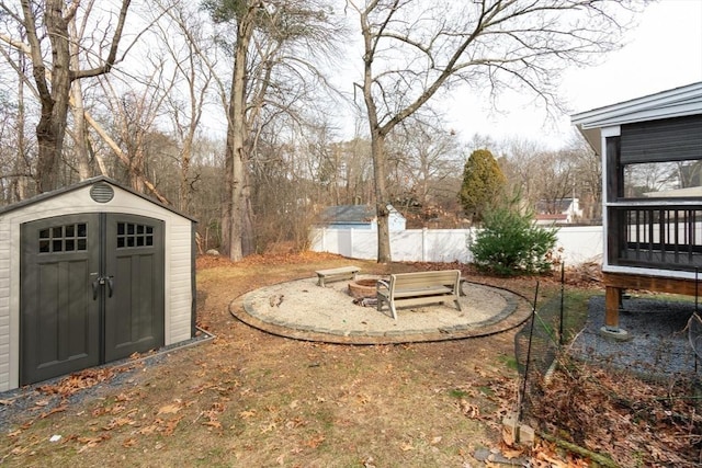 view of yard with a shed and a fire pit