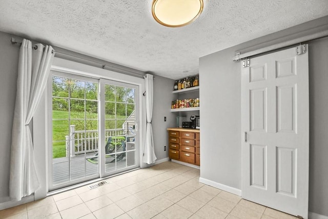 11 Fernwood Dr Unit D, Leominster, MA 01453 - doorway to outside featuring baseboards, a textured ceiling, and light tile patterned floors