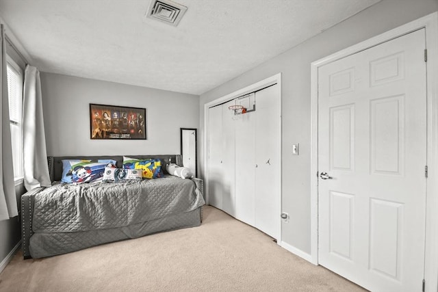 11 Fernwood Dr Unit D, Leominster, MA 01453 - carpeted bedroom featuring baseboards, a closet, and a textured ceiling