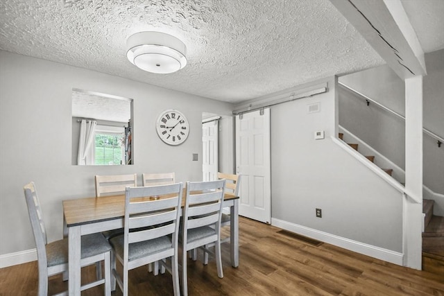 11 Fernwood Dr Unit D, Leominster, MA 01453 - dining space with wood finished floors, baseboards, stairs, and a textured ceiling