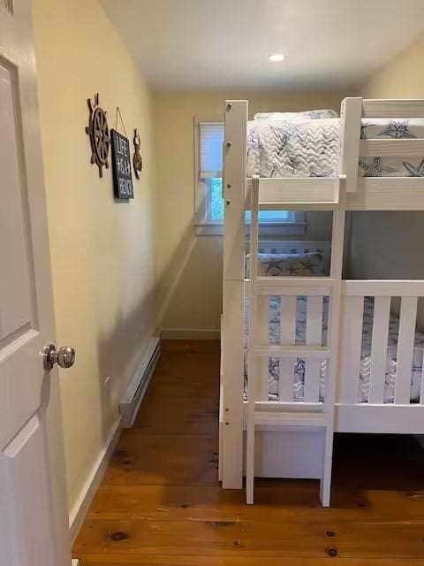 168 N Shore Blvd Unit 12, Sandwich, MA 02537 - bedroom featuring baseboards, a baseboard heating unit, and wood finished floors