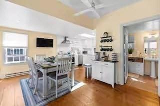 168 N Shore Blvd Unit 12, Sandwich, MA 02537 - dining area with a ceiling fan, a baseboard heating unit, and wood finished floors