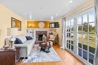 168 N Shore Blvd Unit 12, Sandwich, MA 02537 - living room featuring a brick fireplace and wood finished floors