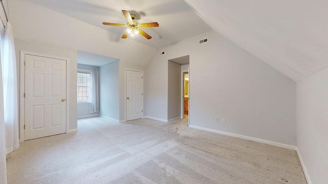 bonus room featuring visible vents, baseboards, ceiling fan, vaulted ceiling, and light colored carpet