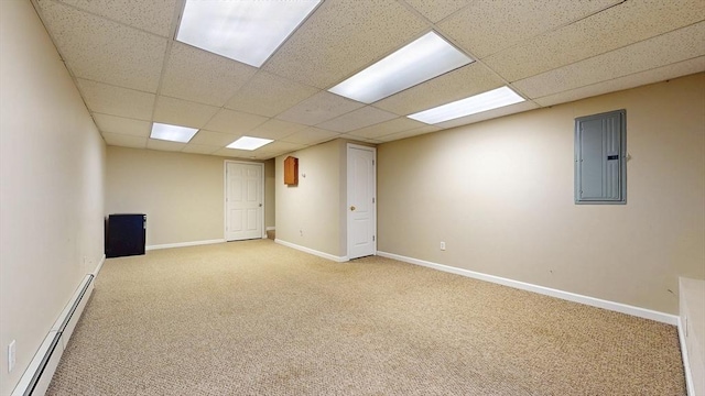 empty room featuring electric panel, baseboards, a baseboard heating unit, carpet, and a drop ceiling