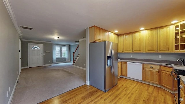 kitchen featuring visible vents, dishwasher, a sink, stainless steel refrigerator with ice dispenser, and range with electric stovetop