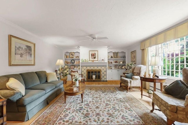 8 Viking Rock Rd, Yarmouth, MA 02664 - living room with healthy amount of natural light, ceiling fan, ornamental molding, built in shelves, and a fireplace