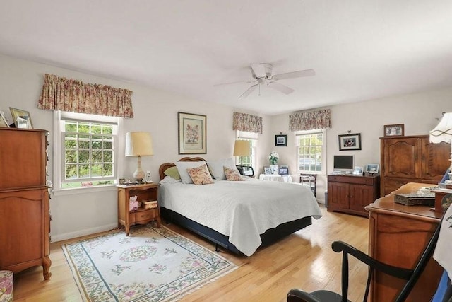 8 Viking Rock Rd, Yarmouth, MA 02664 - bedroom with multiple windows, light wood-style flooring, a ceiling fan, and a desk