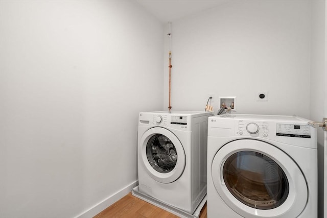 100 Linden St Unit 103, Wellesley, MA 02482 - washroom featuring washer and dryer, light wood finished floors, and baseboards
