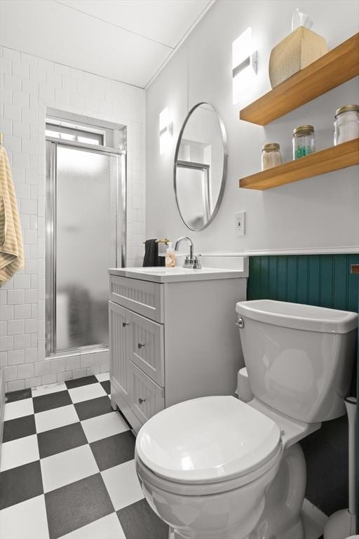 full bathroom with tile patterned floors, a stall shower, toilet, and vanity