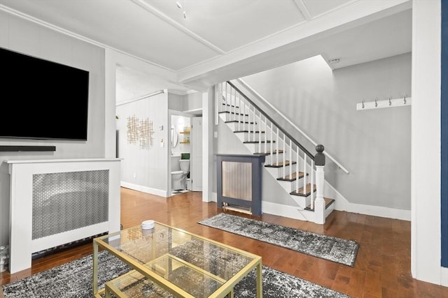 living room with stairway, wood finished floors, and baseboards