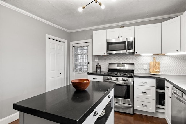 kitchen featuring stainless steel appliances, tasteful backsplash, dark countertops, and dark wood finished floors