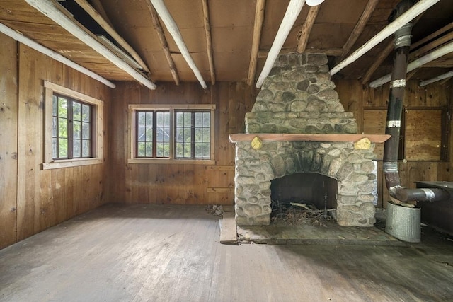 731-R Grove St, Norwell, MA 02061 - unfurnished living room with hardwood / wood-style flooring, a stone fireplace, and wood walls