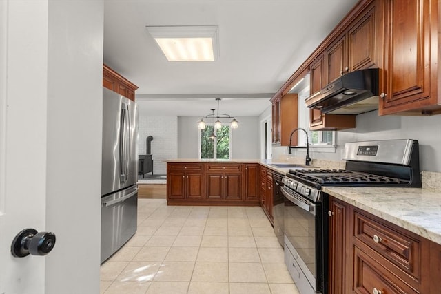 731-R Grove St, Norwell, MA 02061 - kitchen featuring appliances with stainless steel finishes, exhaust hood, a wood stove, a peninsula, and light tile patterned floors