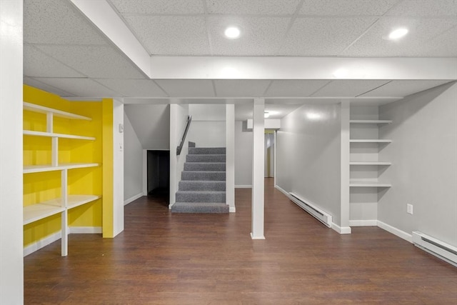 731-R Grove St, Norwell, MA 02061 - finished below grade area with baseboard heating, stairs, wood finished floors, a drop ceiling, and recessed lighting