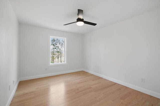 empty room featuring baseboards, light wood-style floors, and a ceiling fan