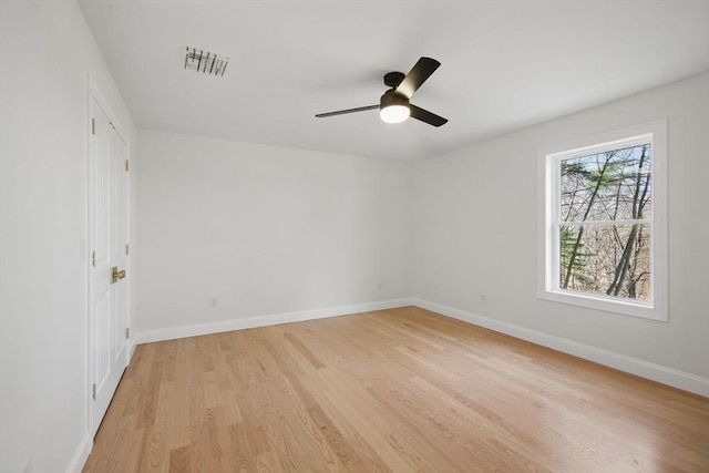 spare room with visible vents, ceiling fan, baseboards, and light wood-style floors