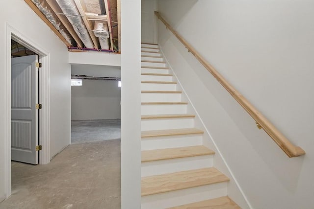 stairs with unfinished concrete floors