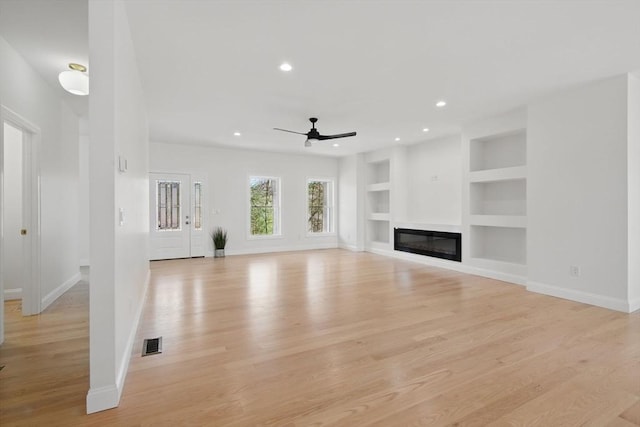 unfurnished living room featuring built in shelves, a ceiling fan, visible vents, recessed lighting, and light wood-style floors