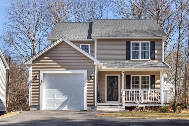 traditional-style home with aphalt driveway, covered porch, a shingled roof, and a garage