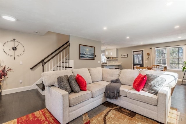 living area featuring recessed lighting, stairs, baseboards, and wood finished floors