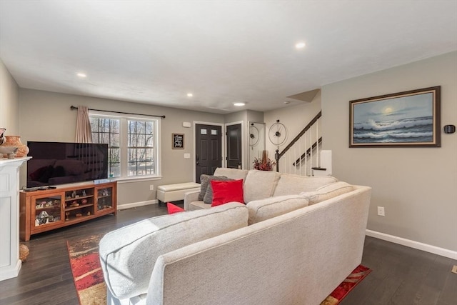 living room with recessed lighting, baseboards, dark wood finished floors, and stairs