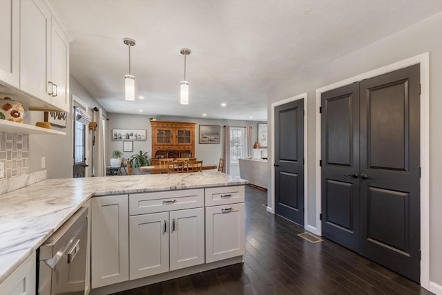 kitchen featuring dark wood-style floors, a peninsula, open shelves, white cabinets, and pendant lighting