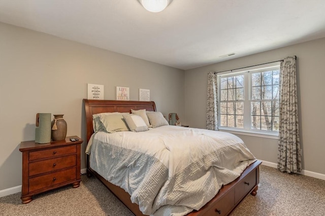 bedroom with visible vents, baseboards, and light carpet