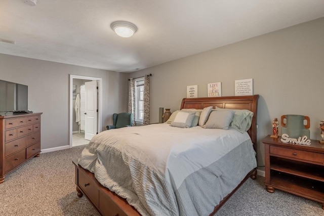 bedroom featuring light colored carpet, connected bathroom, and baseboards