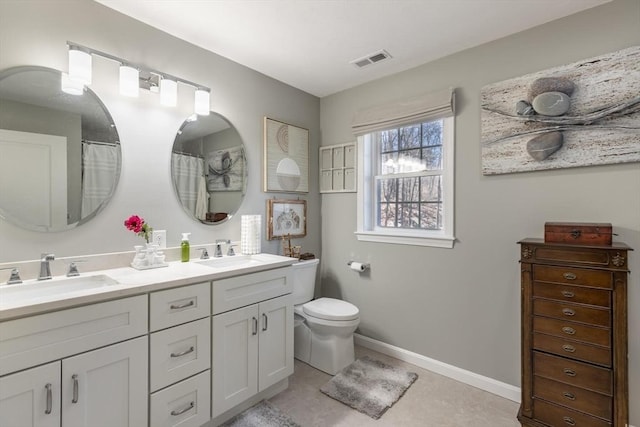 bathroom with a sink, visible vents, baseboards, and toilet