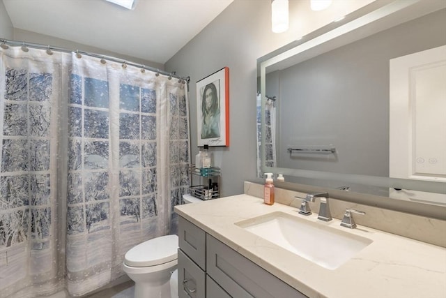 bathroom with vanity, a shower with shower curtain, and toilet