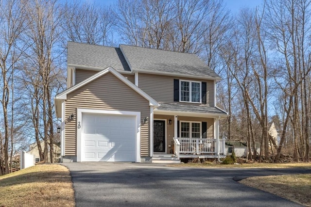 traditional-style home with a garage, a porch, a shingled roof, and aphalt driveway