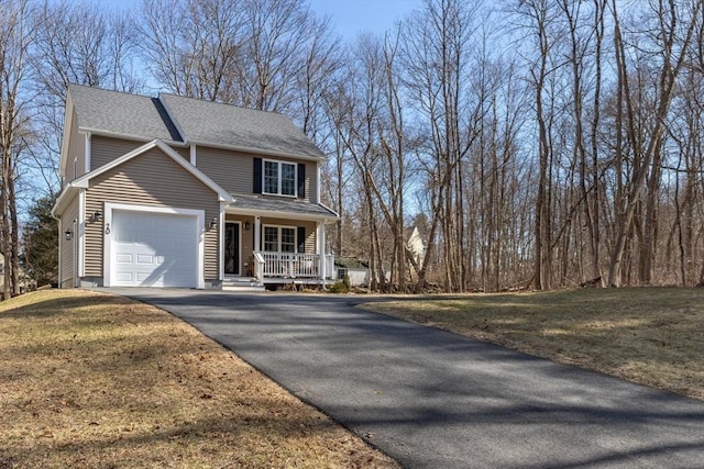 view of front of house with a front lawn, driveway, covered porch, an attached garage, and a shingled roof