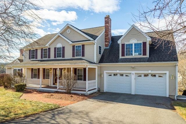 view of front of home featuring a porch and a garage